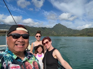 Santos family on a boat with mountains